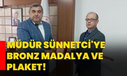 Müdür Sünnetci'ye bronz madalya ve plaket!