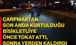Çarpmaktan son anda kurtulduğu bisikletliye önce tokat attı, sonra yerden kaldırdı