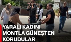 Yaralı kadını montla güneşten korudular