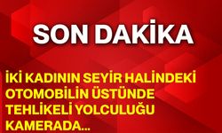 İki kadının seyir halindeki otomobilin üstünde tehlikeli yolculuğu kamerada
