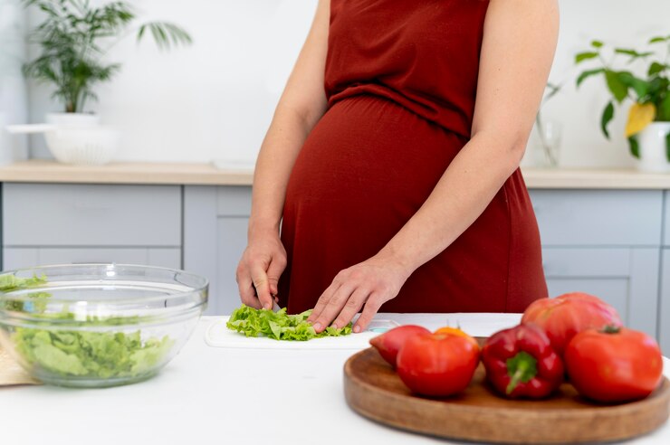 Close Up Pregnant Woman Cutting Lettuce 23 2149116636